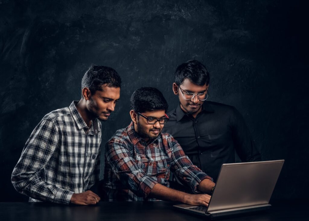 Students preparing for the NISM exam on a laptop